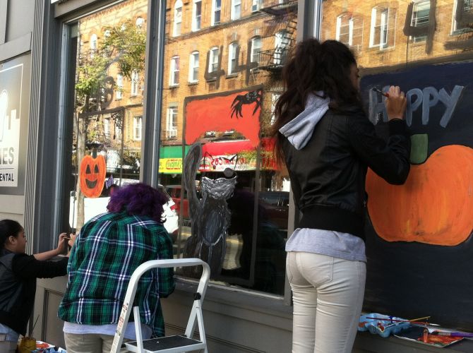 Students-painting-jersey-city-business-windows-for-halloween